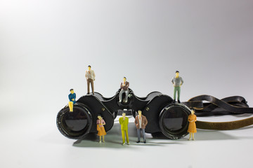 miniature business people team with binoculars font view.