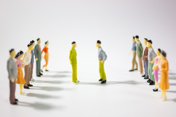 Two team of miniature business people confront on white background.