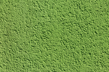 Decorative green plaster texture on the wall. Texture of the green stucco wall for background