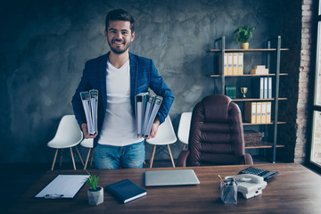 Being an accountant is easy! Confident man happily looks into the camera holding a folder of...