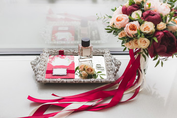 Wedding set - bouquet with roses, peony and silk ribbons, rings, perfume, invitation cards, boutonniere on silver tray