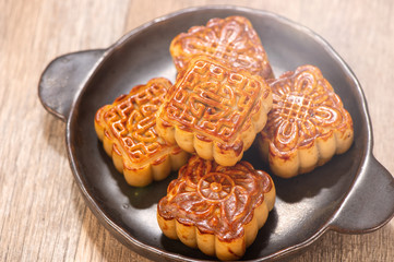 Mooncake in chinese traditional mid-autumn festival(moon festival) with copy space(text space) and table setting, close up.