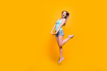 Fototapeta na wymiar Full-body portrait of gorgeous blond model jump high and rejoice isolated on vivid yellow background with copyspace for text