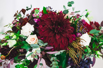 Wedding decorations with fresh red and vinous color flowers close up. Flowers arrangement on party