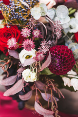Wedding decorations with fresh red and vinous color flowers close up. Flowers arrangement on party