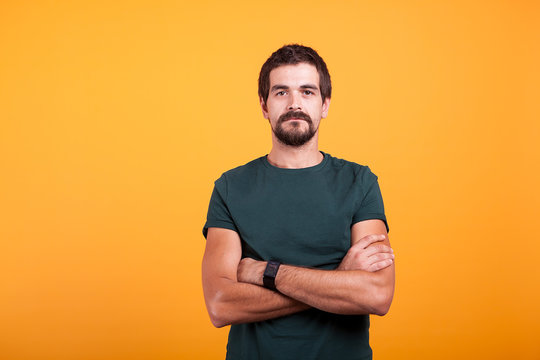 Serious Man Isolated On Orange Background. Confident Person Looking In The Camera