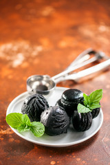 Black ice cream ball with  macaroons.