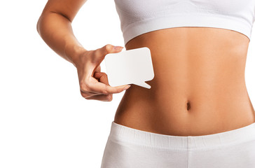 Woman holding question mark over her abdomen 