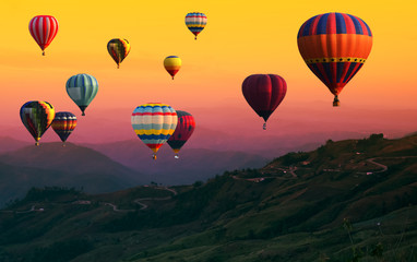 Hot Air balloons flying over road in forest landscape sunset background. - 215781797