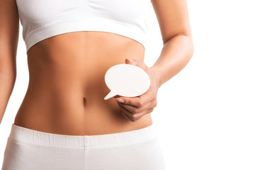 Woman holding question mark over her abdomen 
