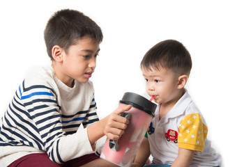 Little sibling boy brothers checking there high  tall each other