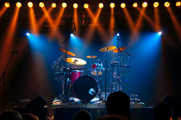 Drum Set on stage, illuminated by stage lights
