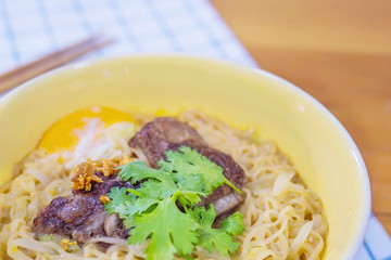 Instant noodle with pork and egg ready to be eaten - delicious instant food menu concept