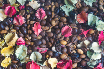 background of roasted coffee beans with colourful dried Potpourri