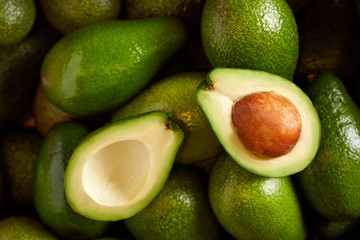 Bunch of fresh avocados in the organic food market - obrazy, fototapety, plakaty