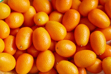 Bunch of fresh kumquats in the organic food market