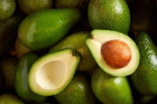 Bunch of fresh avocados in the organic food market