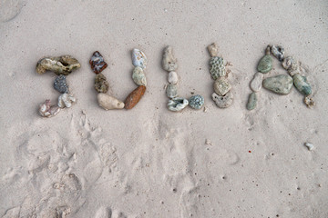 Julia name made by corals on the beach