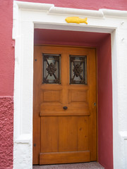 Fototapeta na wymiar Vintage wooden door with decorative metal bar on window. Heidelberg, Germany. 