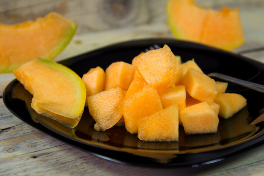 Summer fruits. Tasty and juicy cut melon into cubes served on a plate