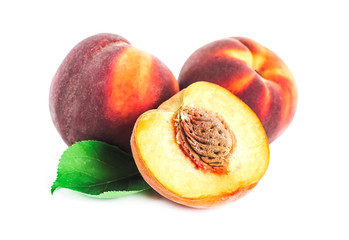 Peach fruit half with leaf isolated on white background