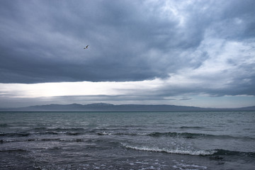 Scenic view of lake with mountains on horizon at sunset
