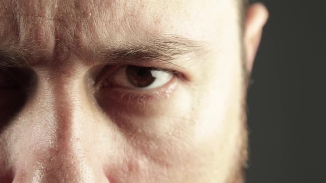 Extreme close up of man eye looking angry