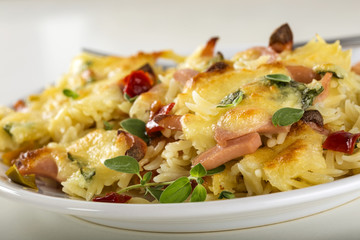 Baked risotto with mozzarella and sausages on plate