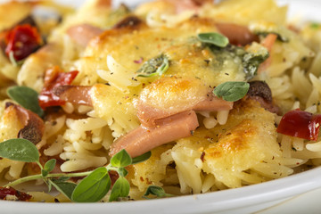 Baked risotto with mozzarella and sausages on plate