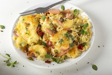Baked risotto with mozzarella and sausages on plate