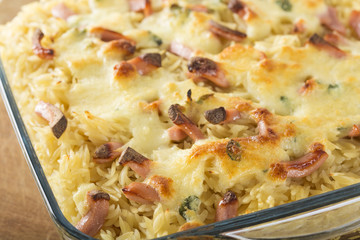 Baked risotto with mozzarela and sausages in tray