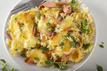 Baked risotto with mozzarella and sausages on plate