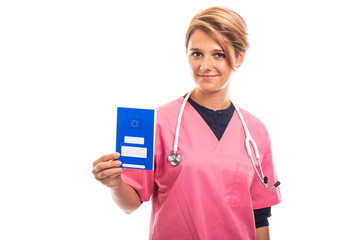 Portrait of female vet holding blue european health insurance card.