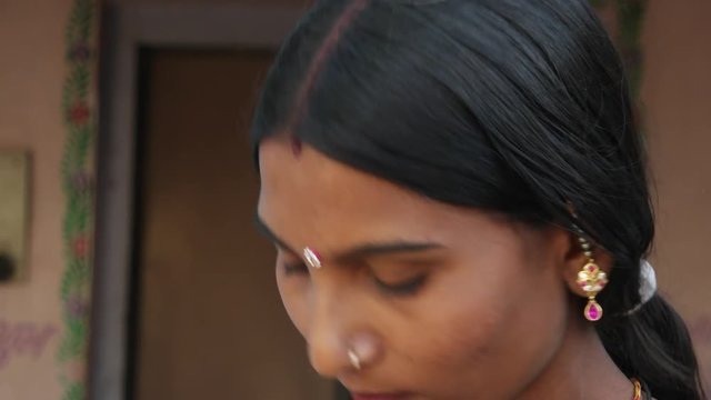 Beautiful Indian newly married young woman in traditional costumes in domestic setting clothes looks worried thinks deep looks around walk in out frame focus shift lock down static suspicious curious