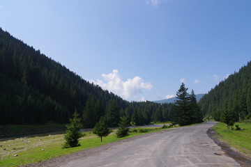 Fototapeta na wymiar road among mountains and blue sky