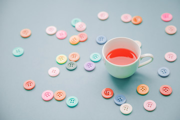 Morning cup of red tea on the table top view in flat lay pastel style .Beautiful breakfast and Daisy flower
