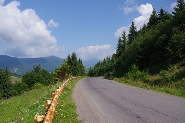 road among mountains and blue sky