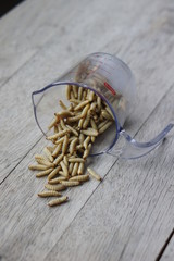 Waxworms in a measuring cup