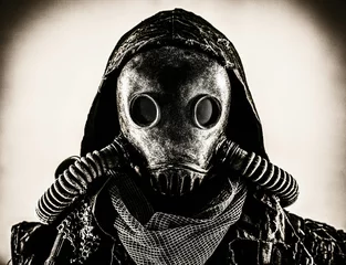 Fotobehang Close up portrait of nuclear post-apocalypse survivor, living underground mutant or creature, skilled stalker wearing rags and armored full-face gas mask or air breathing apparatus, toned shoot © Getmilitaryphotos