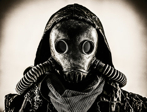 Close up portrait of nuclear post-apocalypse survivor, living underground mutant or creature, skilled stalker wearing rags and armored full-face gas mask or air breathing apparatus, toned shoot