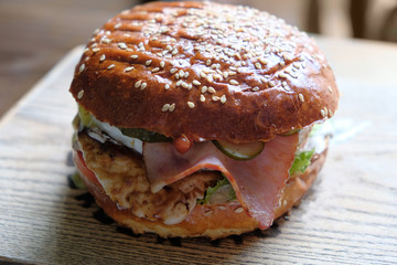 Mouth-watering delicious craft burger on the wooden table.