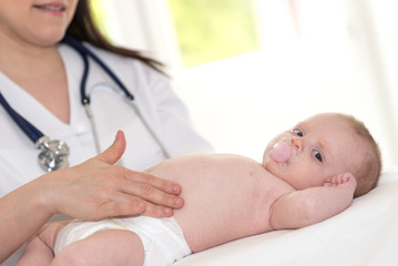 Pediatrician examining baby