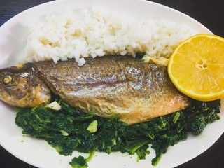Seafood on the plate, fish with rice and lemon and mangel 
