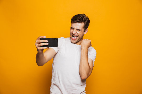 Portrait of a happy young man taking a selfie