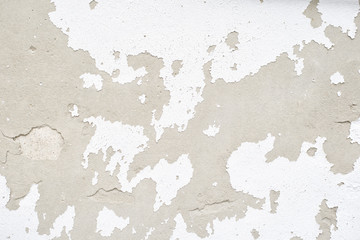 Wall with white peeling plaster. Close up