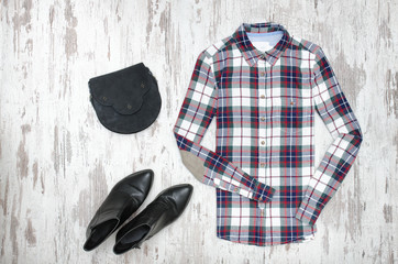 Checkered shirt and black shoes. Fashionable concept