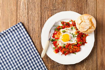 Shakshouka, dish of eggs poached in a sauce of tomatoes, chili peppers, onions