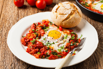 Shakshouka, dish of eggs poached in a sauce of tomatoes, chili peppers, onions
