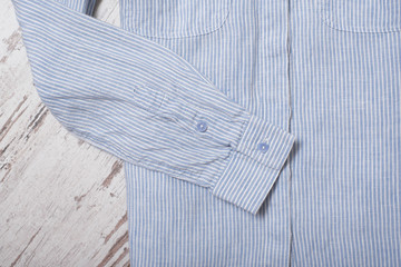 Fashionable concept. Sleeve blue striped shirt. Top view