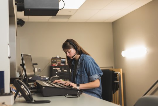 Female sound recordist working in recording studio